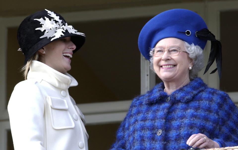 CHELTENHAM, UNITED KINGDOM - MARCH 13:  Queen Elizabeth Ll Laughing And Joking With Her Granddaughter, Zara Phillips, On Gold Cup Day At The Cheltenham National Hunt Festival. (queen Coat By Hardy Amies And Hat By Frederick Fox - D.mail 14.3.03)  (Photo by Tim Graham Photo Library via Getty Images)