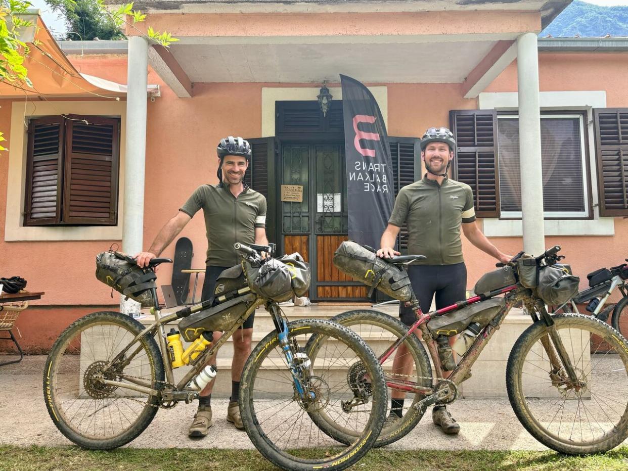 Joey Landine and Keenan Cook, seen here at the finish line of a 1,370 kilometre race, successfully took on the Trans Balkan Race. (Submitted by Joey Landine - image credit)