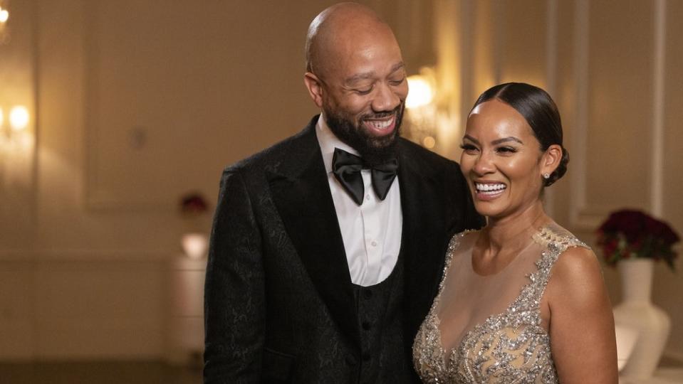 LaVon Lewis and Evelyn Lozada smiling in formal wear in Queens Court