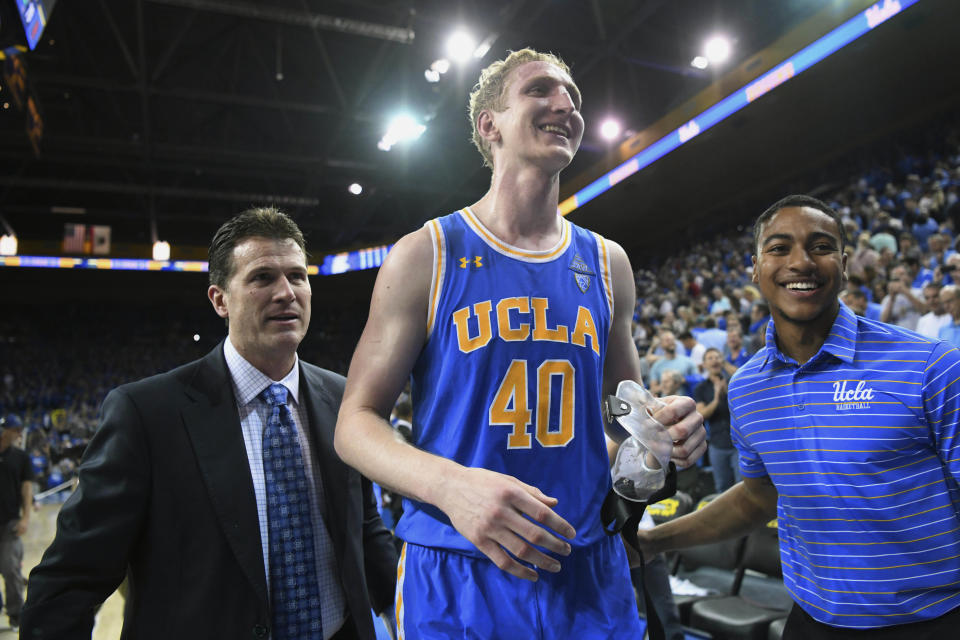 UCLA center Thomas Welsh (40) walks off the court with head coach Steve Alford after scoring 21 points in their 82-79 win over Southern California at an NCAA college basketball game, Saturday, Feb. 3, 2018, in Los Angeles. (AP Photo/Michael Owen Baker)