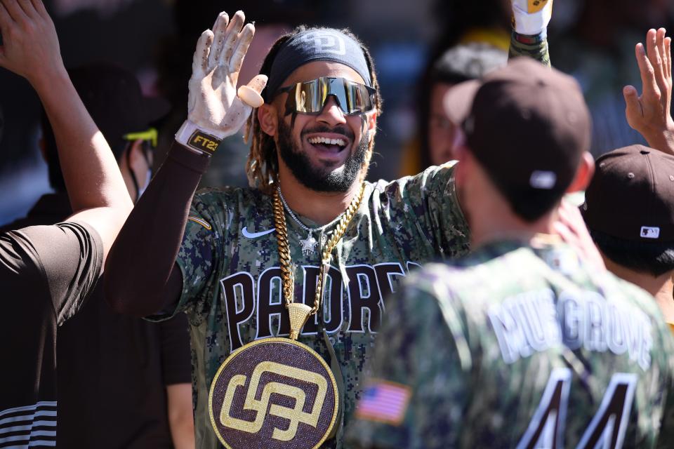 Fernando Tatis Jr. celebrates in the dugout after a grand slam against the Mariners on Sunday.