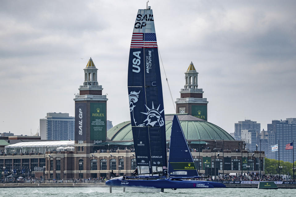 In this photo provided by SailGP, USA SailGP Team, helmed by Jimmy Spithill, sails closely past Navy Pier on Race Day 1 of the United States Sail Grand Prix | Chicago in Chicago, Friday, June 16, 2023. (Bob Martin/SailGP via AP)