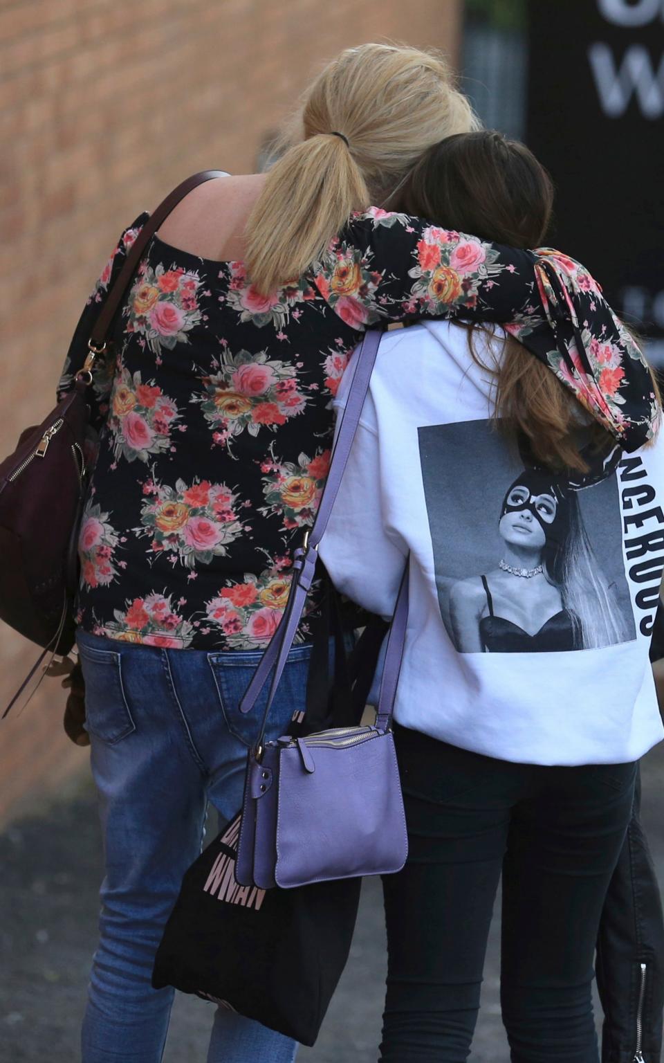 A fan is comforted as she leaves the Park Inn hotel in central Manchester - Credit: Rui Vieira/AP