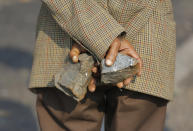 <p>A protestor holds stones to throw at police forces during a violent service delivery protest in Ennerdale, Johannesburg, South Africa, May 9, 2017. (Photo: Kim Ludbrook/EPA) </p>