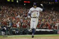 Houston Astros' George Springer celebrates after scoring on a dingle by Yuli Gurriel during the eighth inning of Game 5 of the baseball World Series against the Washington Nationals Sunday, Oct. 27, 2019, in Washington. (AP Photo/Jeff Roberson)