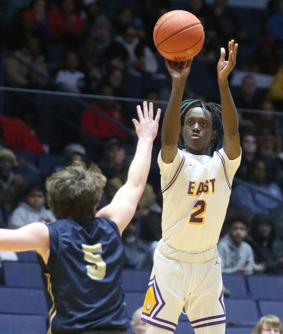 East's Micah Johnson-Breedlove puts up a three point shot over Sutherland's Everett Wilcox during their Class A2 Championship final Saturday, March 4, 2023 a the Blue Cross Arena.