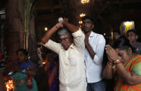 FILE- In this Jan. 15, 2020 file photo, Sri Lankan ethnic Tamil Hindu devotees pray during the harvest festival known as 'Thai Pongal' at a Hindu temple in Colombo, Sri Lanka. A proposed amendment to Sri Lanka’s constitution that will consolidate powers in the President’s hands has raised concerns about the independence of the country’s institutions and the impact on its ethnic minorities who fear their rights could be undermined by the majoritarian will.(AP Photo/Eranga Jayawardena, File)