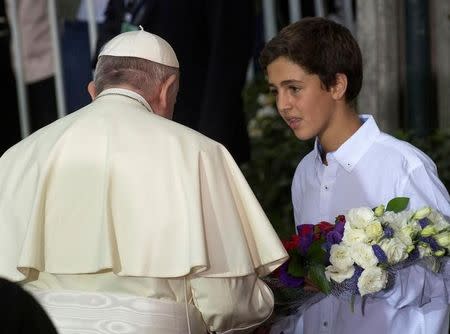 Pope Francis receives flowers outside the nunciature in Santiago, Chile January 15, 2018. REUTERS/Claudio Santana