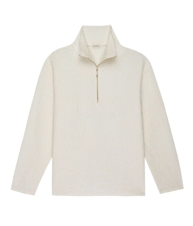 <em>Donni Waffle 1/2 Zip, $234, </em><a href="https://shopdonni.com/collections/tops/products/waffle-pullover-creme" rel="nofollow noopener" target="_blank" data-ylk="slk:available here;elm:context_link;itc:0;sec:content-canvas" class="link ">available here</a><em>.</em>