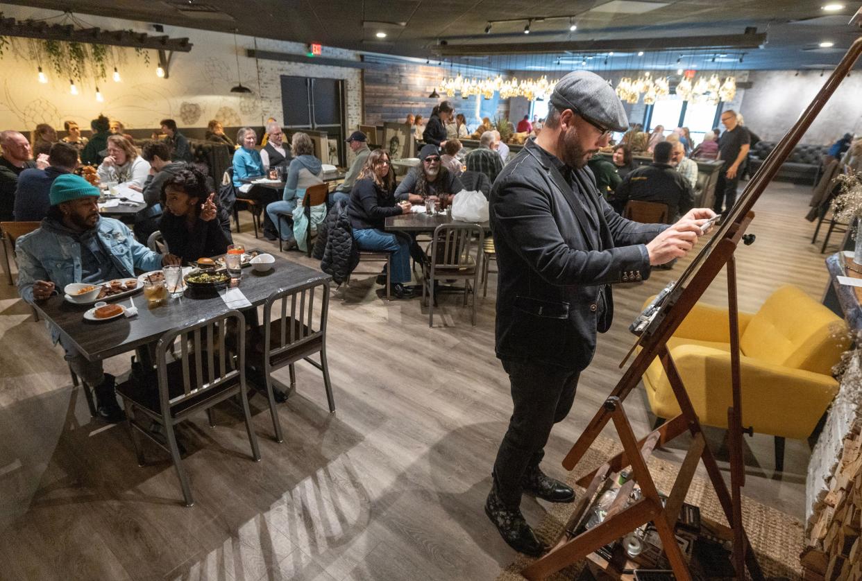 Bruce Budd, director of operations at The Nook Smokehouse & Grille in the Massillon area, works on a charcoal drawing recently during restaurant hours. Budd's live artwork makes eating at The Nook a unique experience.