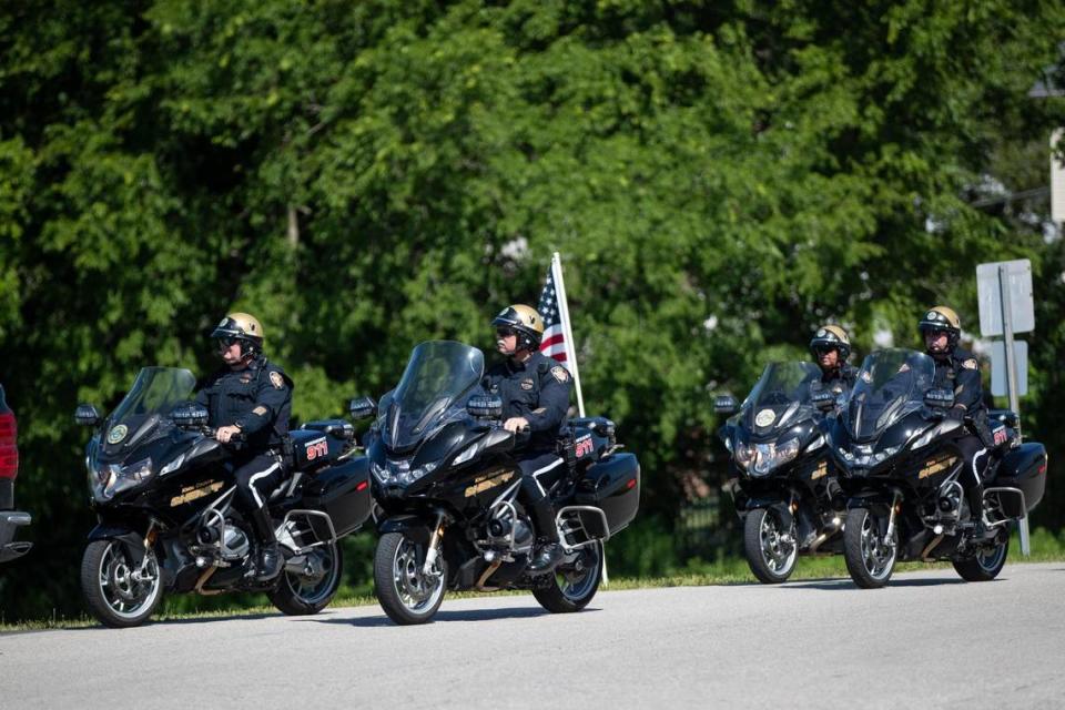 Representatives of the Knox County Sheriff’s Office ride motorcycles at Scott County High School for the funeral service of Scott County Deputy Caleb Conley in Georgetown, Ky., Thursday, June 1, 2023.