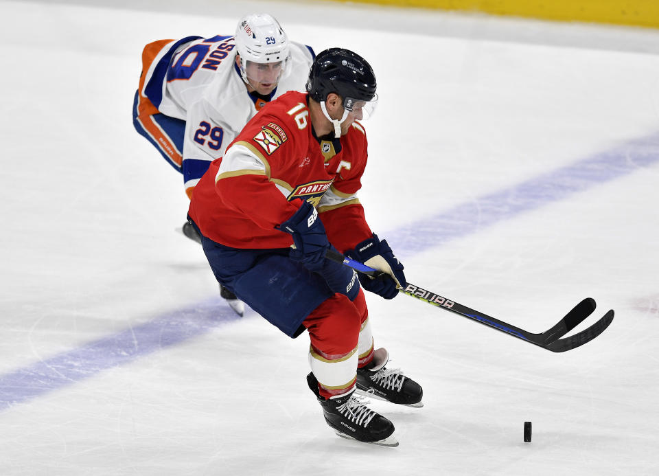 Florida Panthers center Aleksander Barkov (16) skates ahead of New York Islanders center Brock Nelson (29) during the second period of an NHL hockey game, Saturday, Dec. 2, 2023, in Sunrise, Fla. (AP Photo/Michael Laughlin)