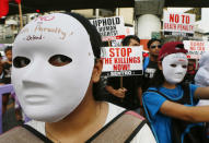 <p>Masked protesters display signs as they gather for a rally near the Presidential Palace to mark International Human Rights Day Saturday, Dec. 10, 2016, in Manila, Philippines. The protesters are calling for an end to extra-judicial killings by the government. (Bullit Marquez/AP) </p>