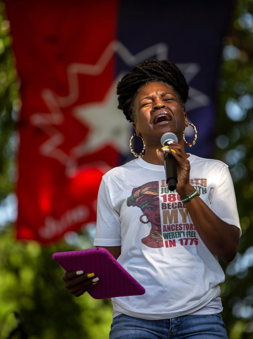 Chereese Dunn performs the Black National Anthem during a "19th is the New 4th" Juneteenth event at Holland Sports Complex in Athens on Saturday, June 18, 2022.  The event marked the third annual Juneteenth event by organizers of ICUC and Ridge Rising Community in partnership with the ACC government, and featured inflatable slides, a bounce house and water fight for the kids, vendors, food trucks and live music.