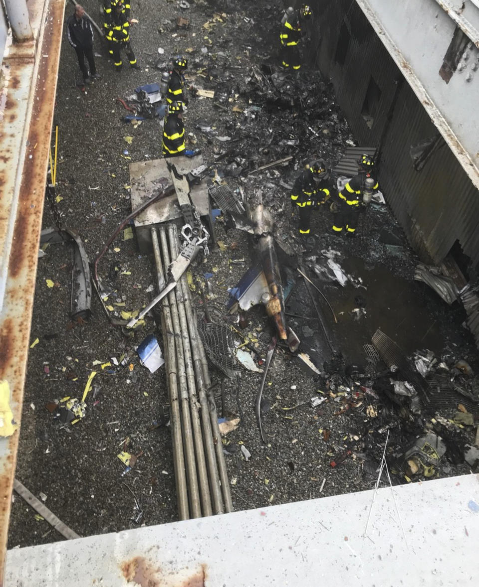 FILE - This June 10, 2019 file photo released by the New York City Fire Department shows damage caused by a helicopter crash on the roof of the AXA Equitable building. Federal investigators said Tuesday, June 25, 2019, that the pilot killed when his helicopter hit the roof of a New York City skyscraper in rain and fog said before takeoff that radar showed a "20-minute window to make it out." (FDNY via AP, File)