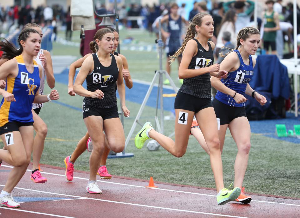 Middletown's Isabelle Walsh (right) steps into the lead at the start of the Division I 1600 meter race ahead of Padua's Anna Bockius (4) and Kelsey Wolff (3) and Analyse Caskey of Caesar Rodney (7) before Walsh won the race during the second day of the DIAA state high school track and field championships at Dover High School, Saturday, May 18, 2024.