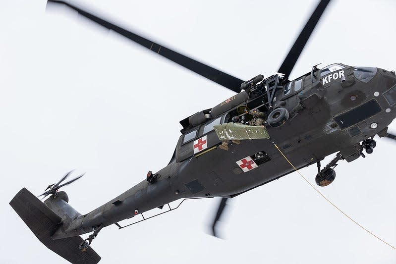 A Rhode Island National Guard air crew operates a hoist in Kosovo during recent medevac training exercises with local search and rescue groups.