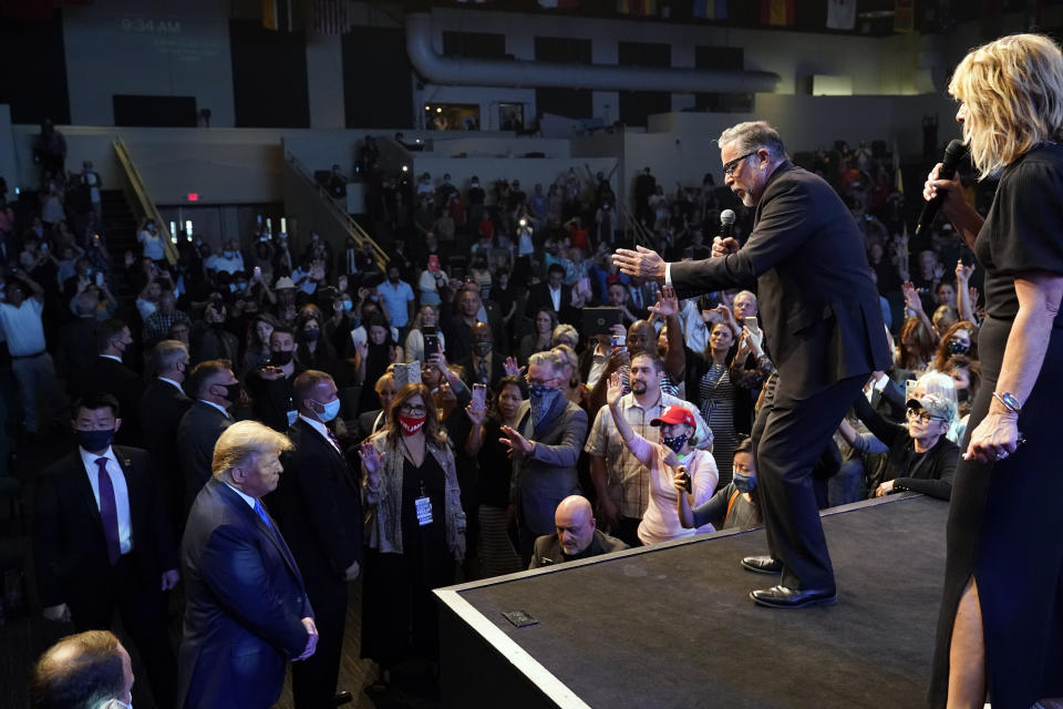 FILE - In this Sunday, Oct. 18, 2020, file photo, President Donald Trump, lower left, attends church at International Church of Las Vegas, as Pastor Pasqual Urrabazo, second from the right, gestures on stage in Las Vegas, Nev. (AP Photo/Alex Brandon, File)