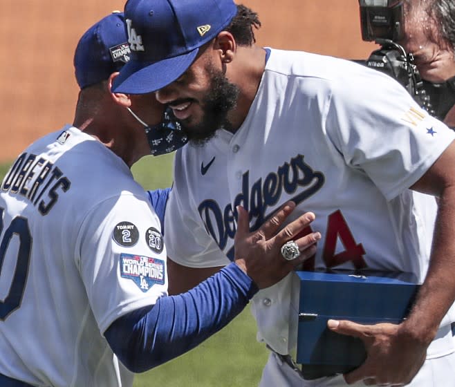 Los Angeles, CA, Friday, April 9, 2021 - Manager Dave Roberts embraces pitcher Kenley Jansen.