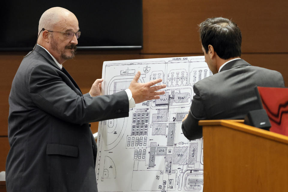 Broward Sheriff's Office Detective John Curcio, left, and defense attorney Mark Eiglarsh discuss building locations using a school map during the trial of former Marjory Stoneman Douglas High School School Resource Officer Scot Peterson at the Broward County Courthouse in Fort Lauderdale, Fla., on Wednesday, June 21, 2023. Broward County prosecutors charged Peterson, a former Broward Sheriff's Office deputy, with criminal charges for failing to enter the 1200 Building at the school and confront the shooter. (Amy Beth Bennett/South Florida Sun-Sentinel via AP, Pool)