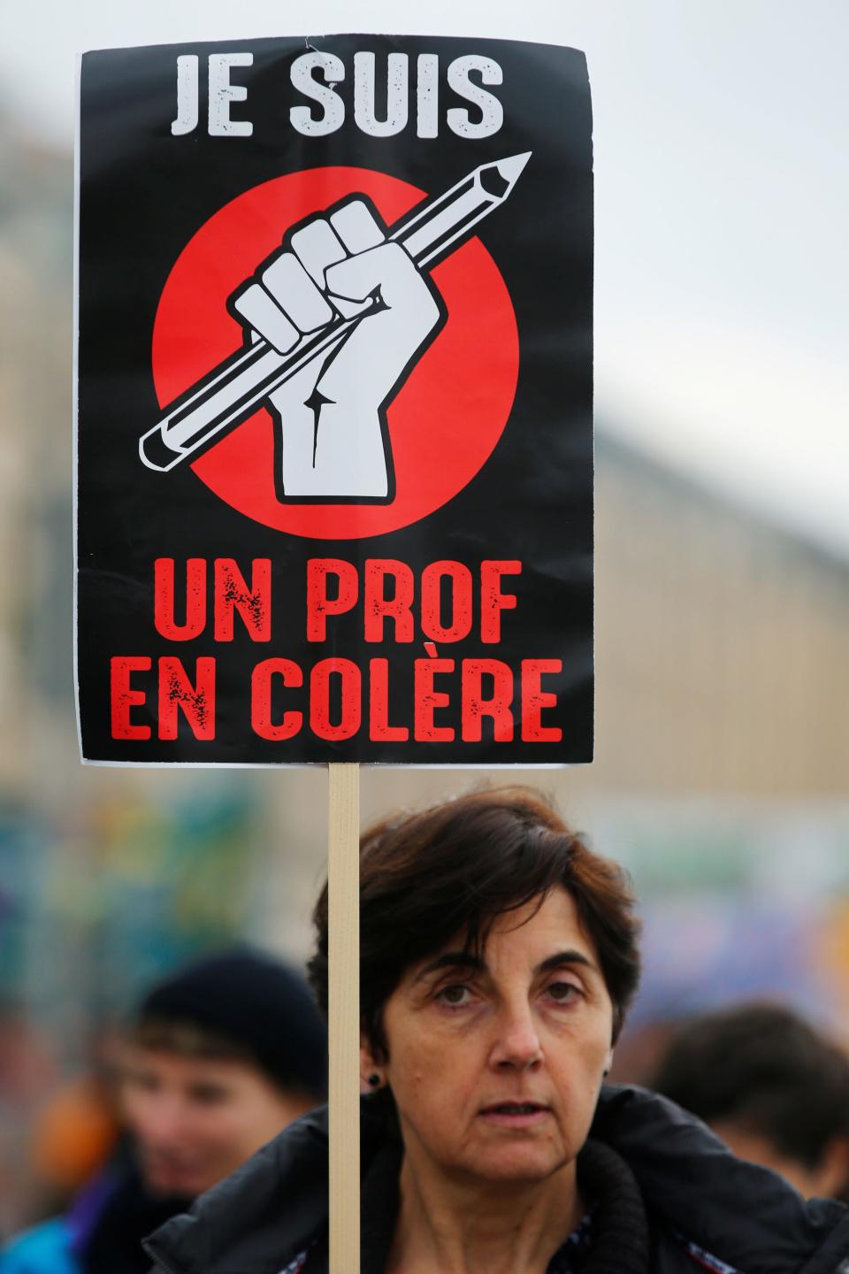 A protester holds a placard as French Labour unions members demonstrate against French government's pensions reform plans in Marseille as part of a day of national strike and protests in France, December 5, 2019.