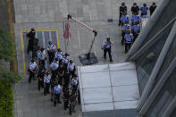 Chinese police and security personnel prepare for duty outside the Evergrande headquarters in Shenzhen, China, Friday, Sept. 24, 2021. Seeking to dispel fears of financial turmoil, some Chinese banks are disclosing what they are owed by the real estate developer that is struggling under $310 billion in debt, saying they can cope with a potential default.(AP Photo/Ng Han Guan)