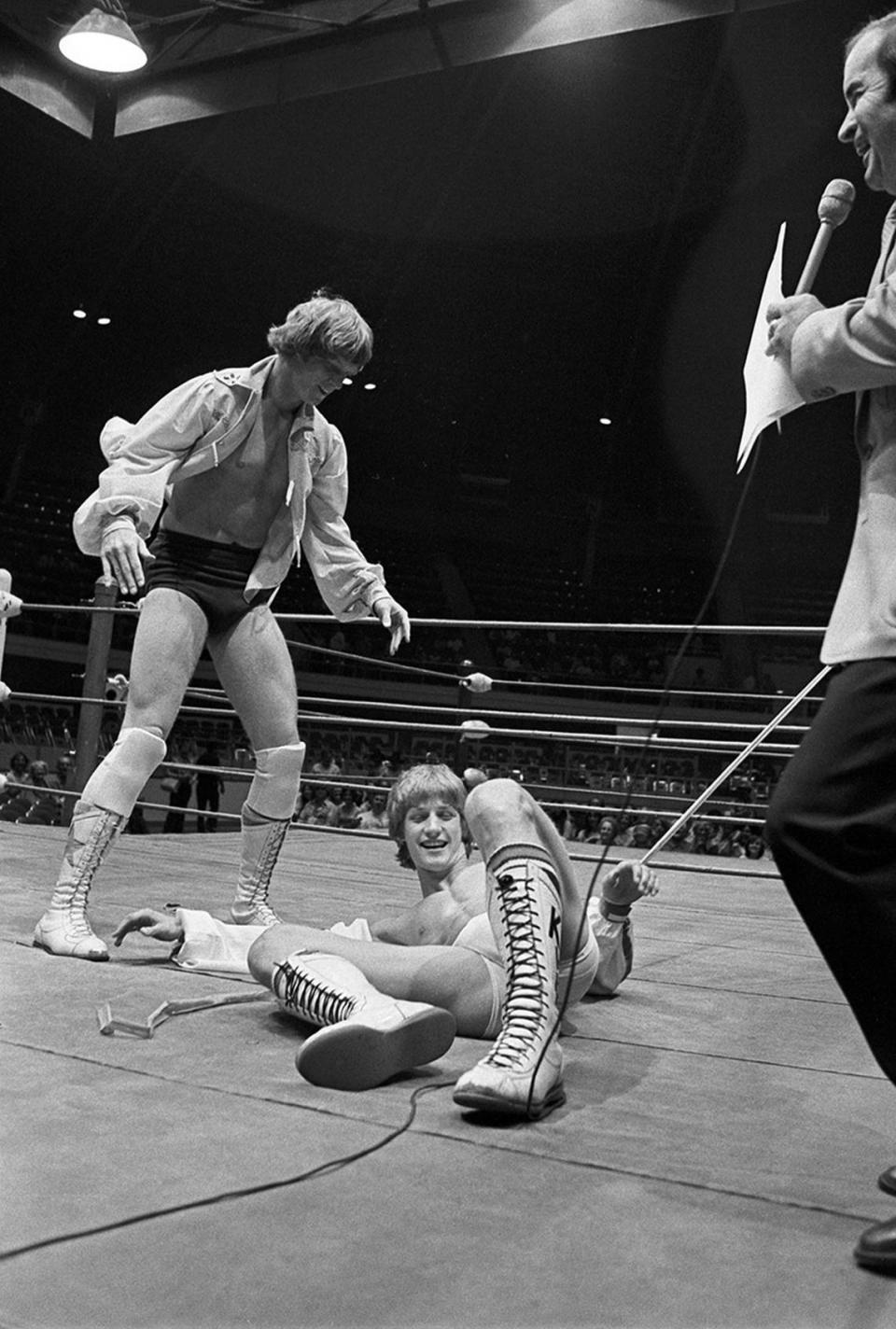 October 9, 1978: Green tights-clad David Von Erich steals the glory from brother Kevin at unique “ribbon slamming” ceremonies at the newly renovated Will Rogers Coliseum, with Miss Texas Sandi Miller and Mayor Hugh Parmer clutching ends of the red crepe paper ribbon. “The grand old lady of Fort Worth” recently completed a $1.2 million facelift, including new seats and new bathrooms, with Fort Worth dignitaries and coliseum patrons viewing the renovation at the gala reopening.