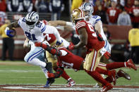 Dallas Cowboys running back Ezekiel Elliott (21) runs against San Francisco 49ers linebacker Azeez Al-Shaair, bottom, and linebacker Dre Greenlaw during the second half of an NFL divisional round playoff football game in Santa Clara, Calif., Sunday, Jan. 22, 2023. (AP Photo/Josie Lepe)