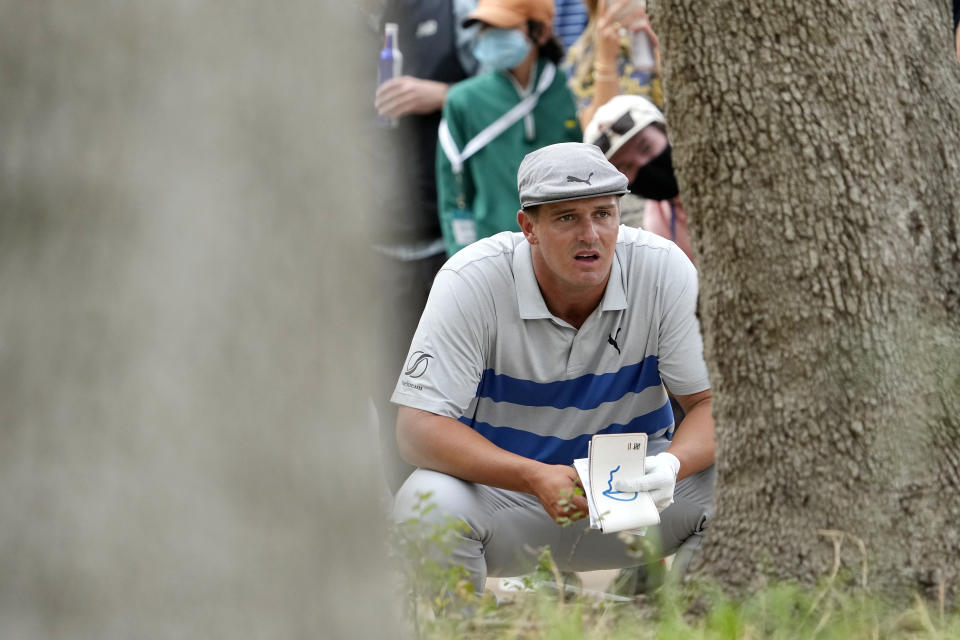 Bryson DeChambeau lines up a shot near the trees on the 16th hole during a first round match at the Dell Technologies Match Play Championship golf tournament Wednesday, March 24, 2021, in Austin, Texas. (AP Photo/David J. Phillip)