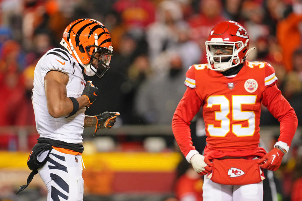 Jan 29, 2023; Kansas City, Missouri, USA; Cincinnati Bengals wide receiver Ja’Marr Chase (1) reacts after making a catch as Kansas City Chiefs cornerback Jaylen Watson (35) looks on during the third quarter of the AFC Championship game at GEHA Field at Arrowhead Stadium. Mandatory Credit: Jay Biggerstaff-USA TODAY Sports