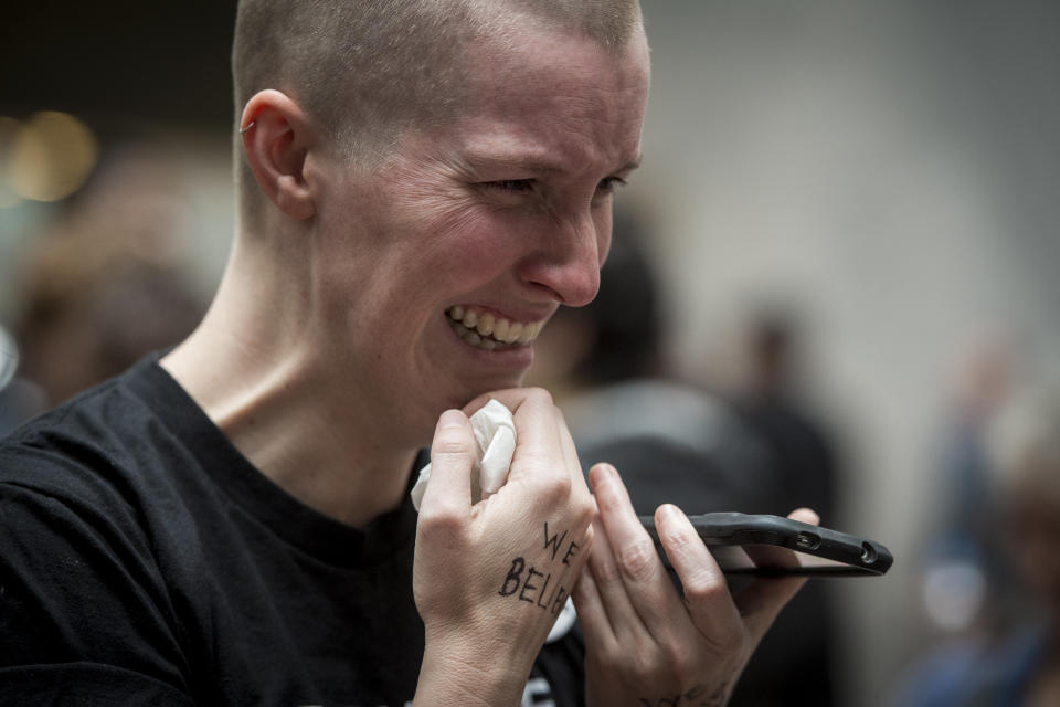 Joy Gerhard, of Seattle, cries in the Hart Senate Office Building atrium as she listens on her phone to Dr. Christine Blasey Ford testimony.