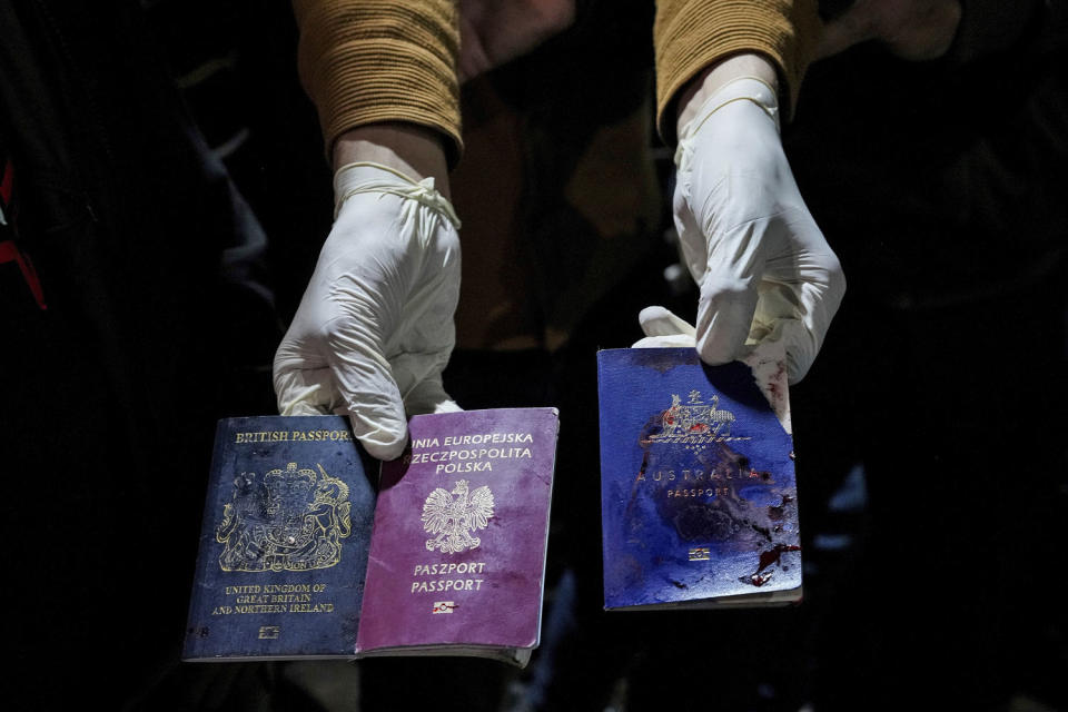 A man shows bloodstained British, Polish and Australian passports after an Israeli airstrike in Deir al-Balah, Gaza, killed seven World Central Kitchen workers on April 1, 2024.  (Abdel Kareem Hana / AP)
