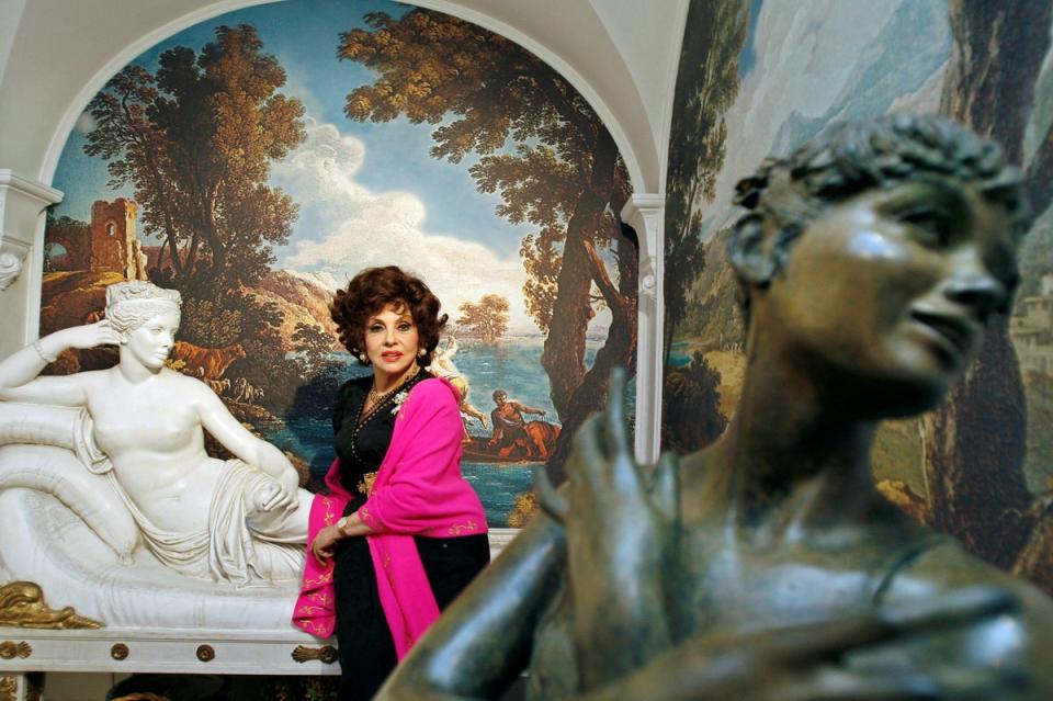 Lollobrigida poses near two of her sculptures in her villa in southern Rome, in December 2006 (REUTERS)