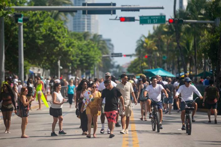 Visitors walk down Ocean Drive and 11th Street in Miami Beach during the Memorial Day weekend on Saturday, May 25, 2019.