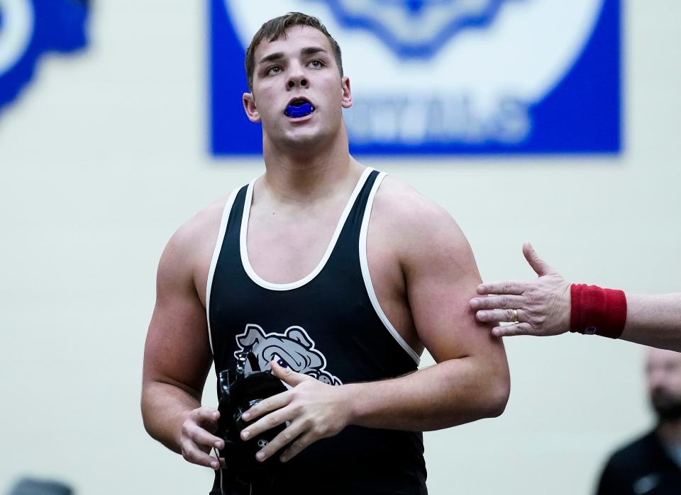 Brownsburg Bulldogs Leighton Jones stands on the mat after defeating Avon Orioles Enoch Shodeinde in the 285-pound weight class during a dual meet on Thursday, Dec. 9, 2021, at Avon High School in Avon. The Brownsburg Bulldogs defeated Avon Orioles , 65-3. 