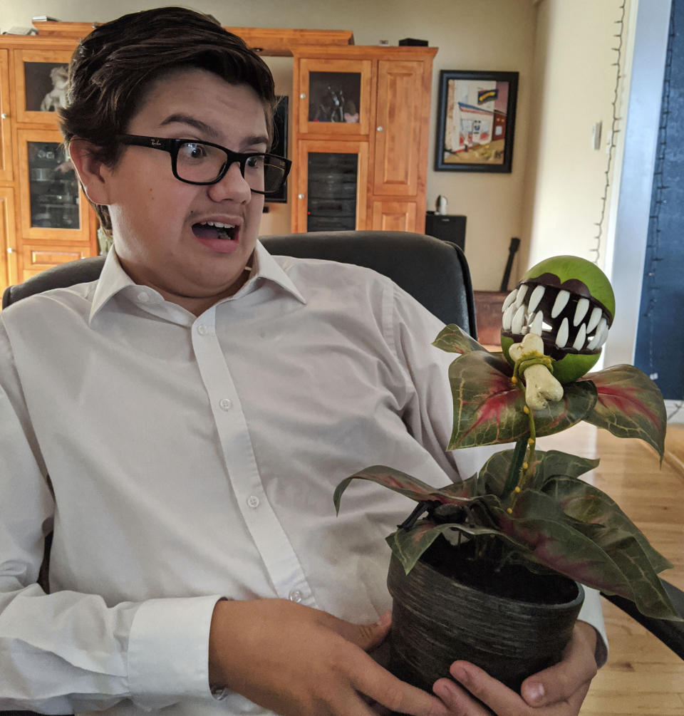 In this Oct. 1, 2020, photo provided by Meredith Christensen-Houghtelling, her son, Logan Houghtelling, dresses up as Seymour Krelborn from "Little Shop of Horrors" for a virtual high school class in San Lorenzo, Calif. (Meredith Christensen-Houghtelling via AP)