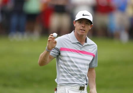 Aug 3, 2014; Akron, OH, USA; Rory McIlroy reacts after sinking his birdie putt on the fifth hole during the final round of the WGC-Bridgestone Invitational golf tournament at Firestone Country Club - South Course. Joe Maiorana-USA TODAY Sports