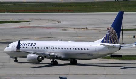 A United Airlines plane with the Continental Airlines logo on its tail, taxis to the runway at O'Hare International airport in Chicago October 1, 2010. REUTERS/Frank Polich