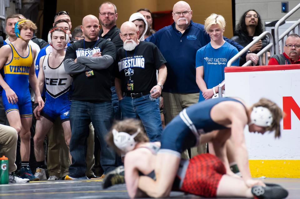 Wrestlers and coaches watch as Northwestern's Sierra Chiesa, bottom, works her way to a 4-2 win over Philipsburg-Osceola's Caleb Hummel in a 107-pound consolation bout at the PIAA Class 2A wrestling championships at the Giant Center on Friday in Derry Township. Chiesa lost in the consolation third-round, finishing 2-2 at the tournament.