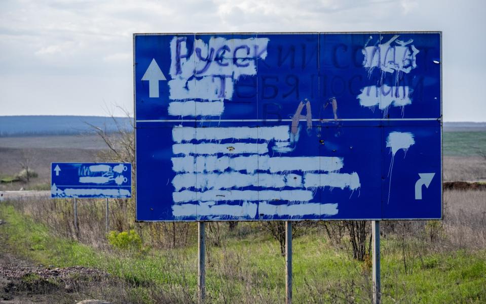Road signs are painted over to confuse Russian forces, and the words, Russian soldier, you have been sent to hell, near a Donbas village that was occupied by invading Russian forces from June to September 2022, in the village of Bohorodychne, Ukraine - Scott Peterson/Getty Images