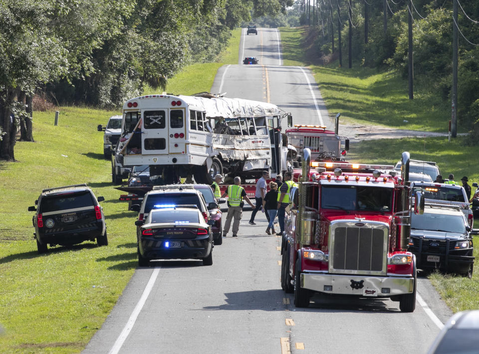 Authorities work at the scene of a deadly crash after a bus carrying farmworkers collided with a pickup truck on State Road 40 Tuesday, May 14, 2024, near Dunnellon, Fla. The driver of the pick up, Bryan Maclean Howard, was charged with eight counts of DUI manslaughter. (AP Photo/Alan Youngblood)