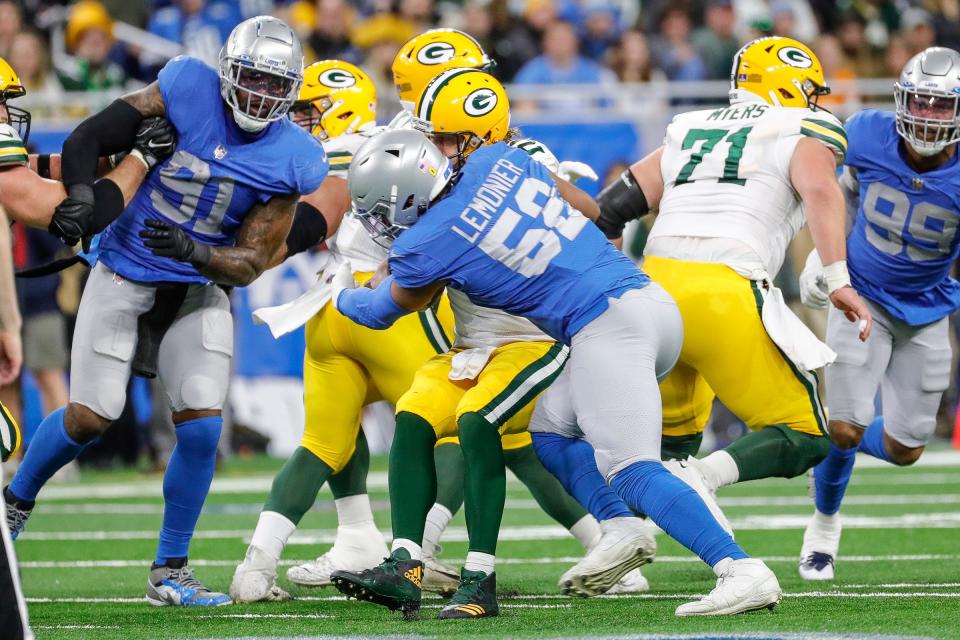 Packers quarterback Aaron Rodgers is sacked by Lions linebacker Jessie Lemonier during the first half on Sunday, Jan. 9, 2022, at Ford Field.