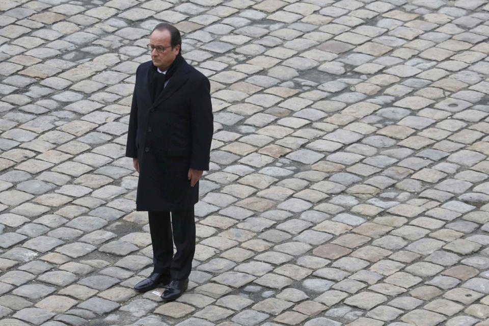 French President Francois Hollande stands at attention as he leads a ceremony to pay a national homage to the victims of the Paris attacks at Les Invalides monument in Paris, France, November 27, 2015. (REUTERS/Jacky Naegelen)