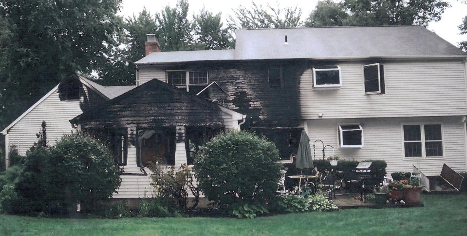 FILE - This July 2007 file photo provided by police, made available Sept. 21, 2011, by the Connecticut Judicial Branch as evidence and presented in the Joshua Komisarjevsky trial in New Haven, Conn., shows a fire-damaged portion of the William Petit home in Cheshire, Conn. The Connecticut Supreme Court issued a 7-0 decision Monday, April 12, 2021, upholding the convictions against Joshua Komisarjevsky. Komisarjevsky and Steven Hayes are serving life prison sentences for the killings of Jennifer Hawke-Petit and her daughters, 11-year-old Michaela and 17-year-old Hayley, in their Cheshire home. (Connecticut Judicial Branch via AP, File)