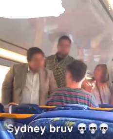 The two male train passengers can be seen intervening during the argument. Source: Reddit