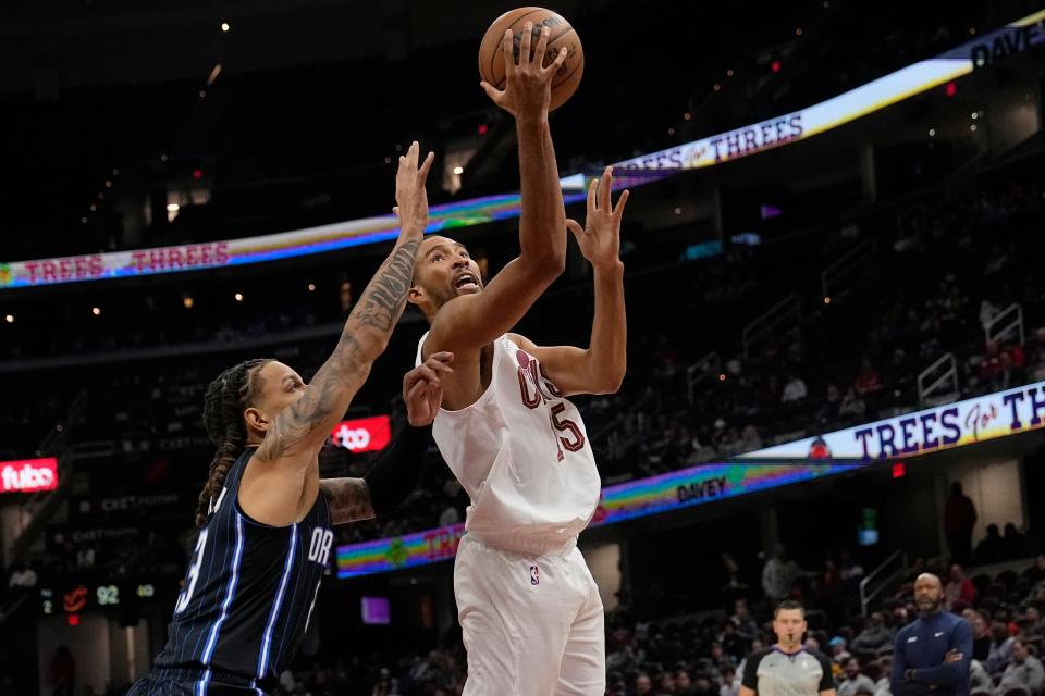 Cleveland Cavaliers' Isaiah Mobley (15) shoots next to Orlando Magic's D.J. Wilson during the second half of a preseason NBA basketball game Thursday, Oct. 12, 2023, in Cleveland. (AP Photo/Sue Ogrocki)