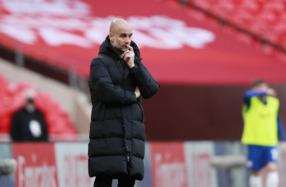 Manchester City's head coach Pep Guardiola stands during the English FA Cup semifinal soccer match between Chelsea and Manchester City at Wembley Stadium in London, England, Saturday, April 17, 2021. (AP Photo/Ian Walton, Pool)