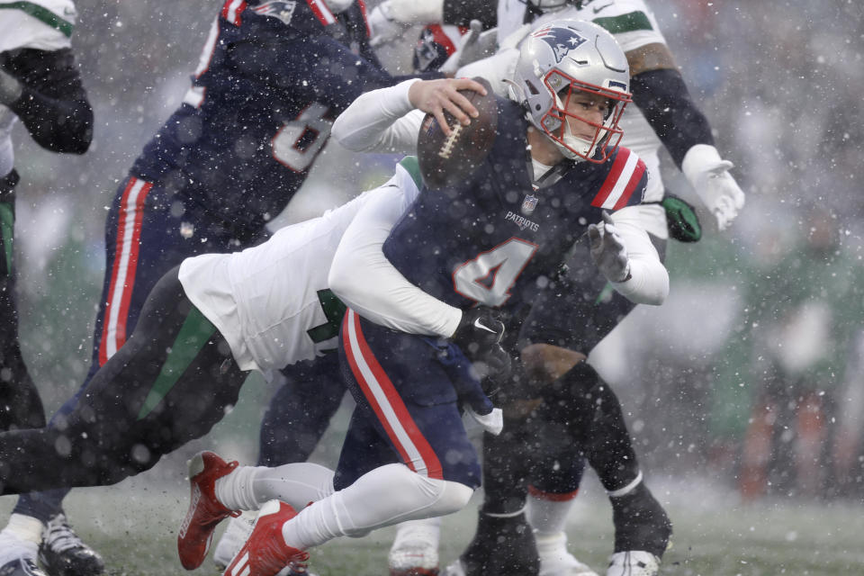 New England Patriots quarterback Bailey Zappe (4) is taken down during the first half of an NFL football game against the New York Jets, Sunday, Jan. 7, 2024, in Foxborough, Mass. (AP Photo/Michael Dwyer)