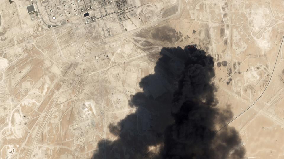 FILE - This Saturday, Sept. 14, 2019, satellite image from Planet Labs Inc., shows thick black smoke rising from Saudi Aramco's Abqaiq oil processing facility in Buqyaq, Saudi Arabia.The weekend drone attack on one of the world’s largest crude oil processing plants that dramatically cut into global oil supplies is the most visible sign yet of how Aramco’s stability and security is directly linked to that of its owner -- the Saudi government and its ruling family. (Planet Labs Inc via AP, File)