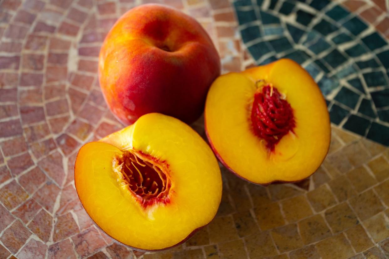 Close up of fresh nectarines on a stone table